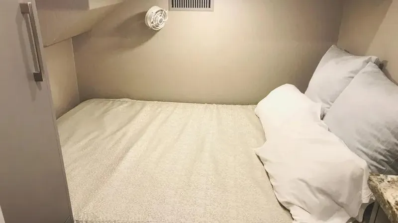 Slide: The Image of Compact bedroom interior in Adonia Inspiration Trip #14, 2019 model, featuring a cozy bed setup. - 16