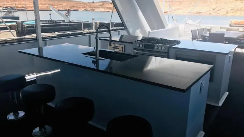 Slide: The Image of Luxurious yacht kitchen with modern appliances, sleek countertops, and scenic water view. Adonia Inspiration Trip #14. - 18