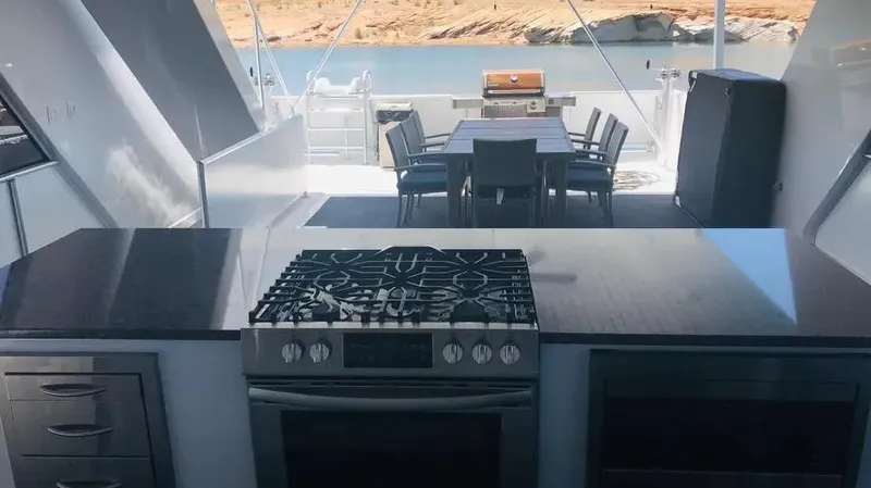Slide: The Image of Modern kitchen and dining area on Adonia Inspiration Trip #14 houseboat, 2019, with scenic water view. - 19