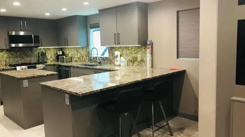 Slide: The Image of Modern kitchen with granite countertops, dark cabinets, and stainless steel appliances, Adonia Inspiration Trip #14. - 4