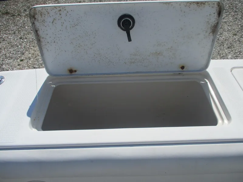 Slide: The Image of Open storage compartment on a 2001 Shamrock 246 Walkaround boat. - 11