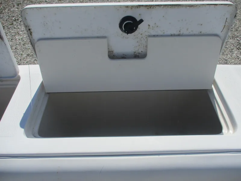 Slide: The Image of Open storage compartment on a 2001 Shamrock 246 Walkaround boat. - 12