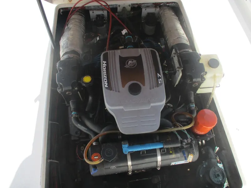 Slide: The Image of Engine compartment of a 2001 Shamrock 246 Walkaround boat, featuring a Horizon 5.7 engine. - 18