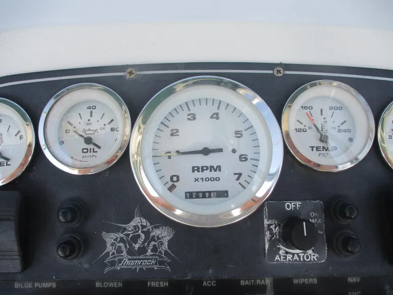 Slide: The Image of Instrument panel of a 2001 Shamrock 246 Walkaround boat with RPM, oil, and temperature gauges. - 22