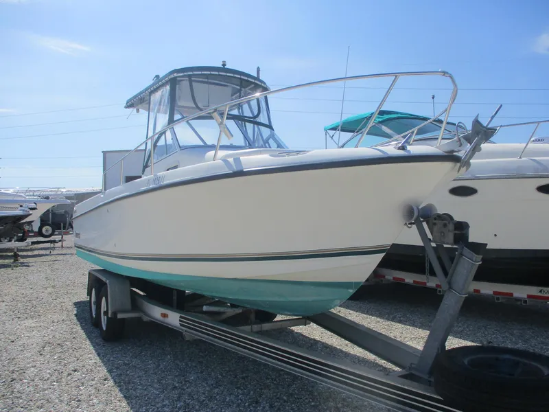 Slide: The Image of 2001 Shamrock 246 Walkaround boat on trailer, parked outdoors under clear sky. - 3