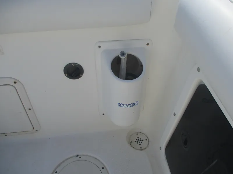 Slide: The Image of 2001 Shamrock 246 Walkaround boat deck with hose holder and drainage features. - 37