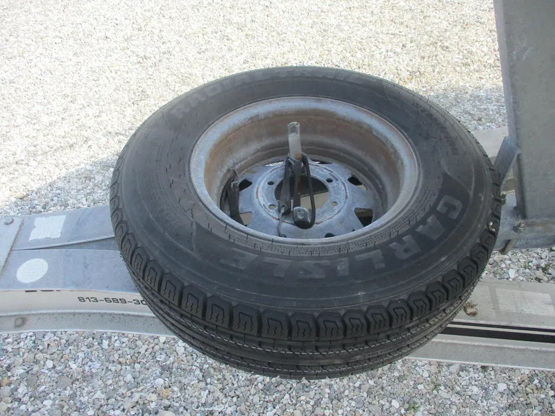 Slide: The Image of Spare tire mounted on a trailer for a 2001 Shamrock 246 Walkaround boat. - 39