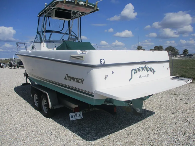 Slide: The Image of 2001 Shamrock 246 Walkaround boat on trailer, clear sky background. - 5