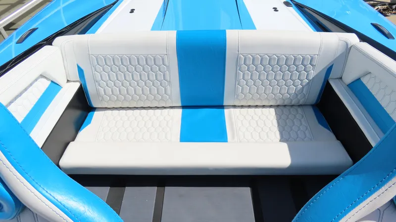Slide: The Image of 2025 Wright Performance P280 boat interior with blue and white seating, featuring hexagonal patterns. - 11