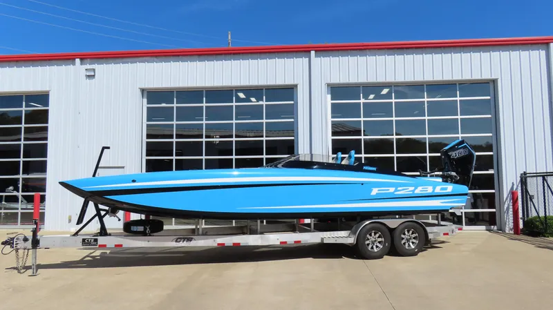 Slide: The Image of 2025 Wright Performance P280 boat on trailer outside a garage. - 13