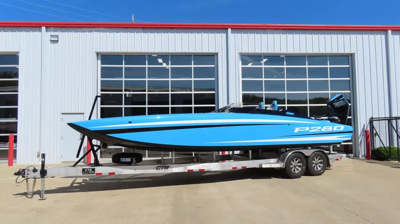 Slide: The Image of 2025 Wright Performance P280 speedboat on trailer outside a garage. - 14