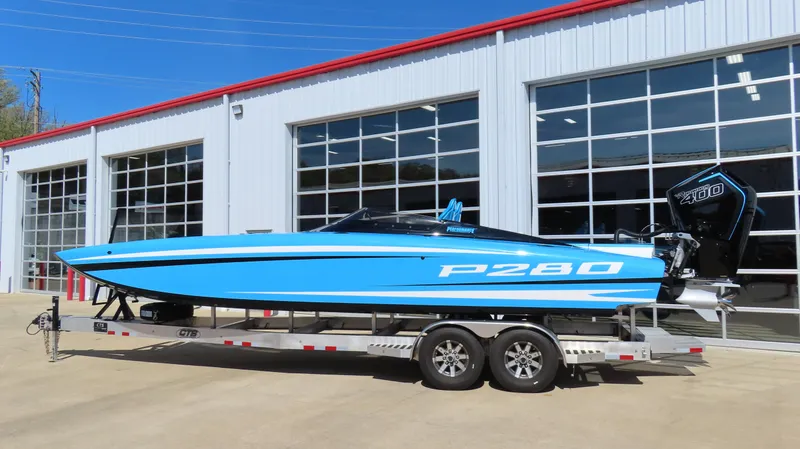 Slide: The Image of 2025 Wright Performance P280 speedboat on trailer, parked outside a garage. - 15