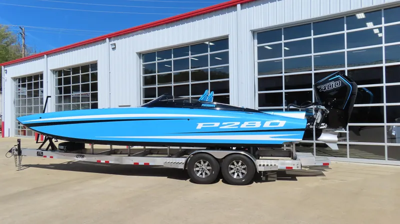 Slide: The Image of 2025 Wright Performance P280 speedboat on trailer, parked outside a garage. - 16