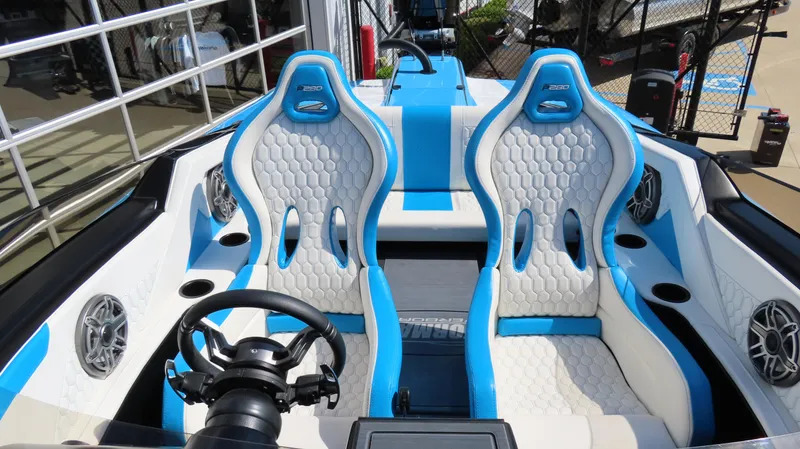 Slide: The Image of 2025 Wright Performance P280 boat interior with blue and white seats, steering wheel, and speakers. - 17