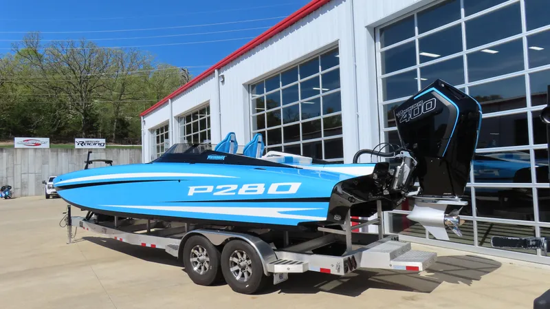 Slide: The Image of 2025 Wright Performance P280 boat on trailer, blue and white, parked outside a modern building. - 4