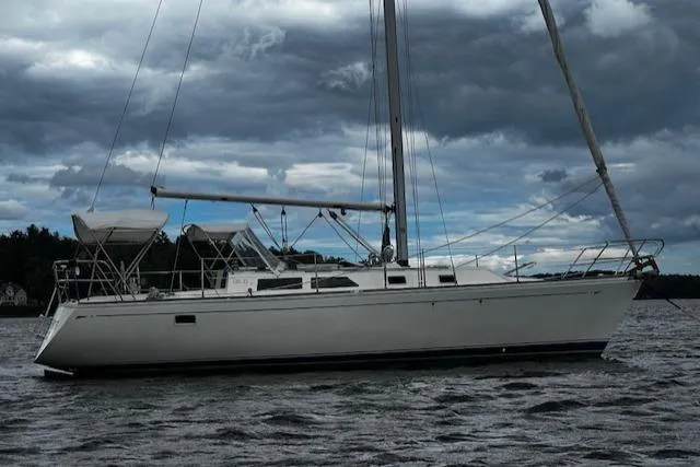 The Image of 1988 CAL Sloop sailboat on water under cloudy sky. - 0