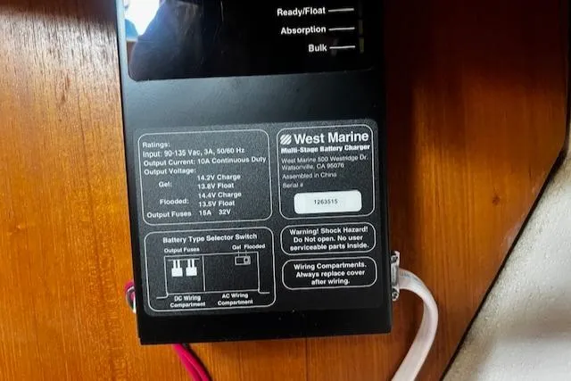 Slide: The Image of West Marine battery charger on 1988 CAL Sloop, showing specifications and safety warnings. - 14