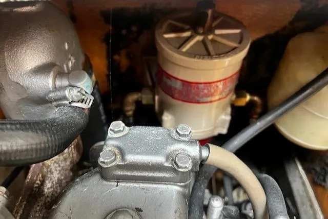 Slide: The Image of Engine components of a 1988 CAL Sloop, featuring hoses and a filter system. - 15