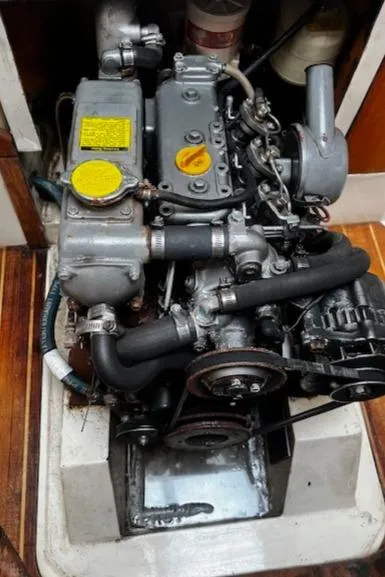 Slide: The Image of Engine of a 1988 CAL Sloop sailboat, showcasing mechanical components and details. - 17