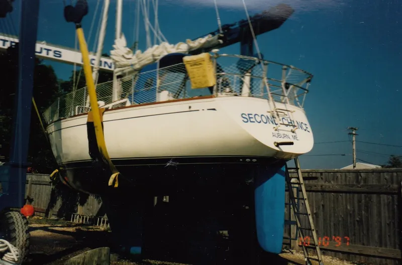 Slide: The Image of 1988 CAL Sloop sailboat named "Second Chance" on a lift in a boatyard. - 19