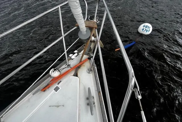 Slide: The Image of Bow of 1988 CAL Sloop with mooring buoy on dark water. - 21