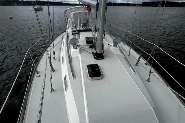 Slide: The Image of 1988 CAL Sloop sailboat on calm water, showcasing deck and rigging. - 23