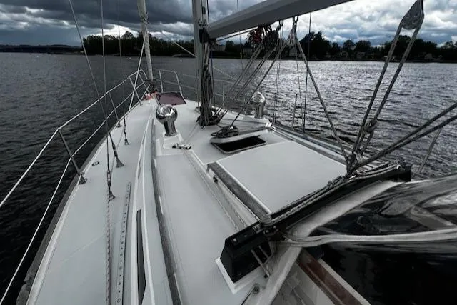 Slide: The Image of 1988 CAL Sloop sailboat on a lake under cloudy skies. - 27