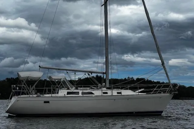 Slide: The Image of 1988 CAL Sloop sailboat on water under cloudy sky. - 32