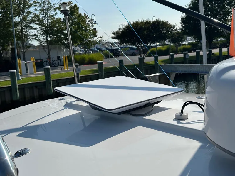 Slide: The Image of 2019 Regulator 28 boat with mounted satellite dish at marina. - 17
