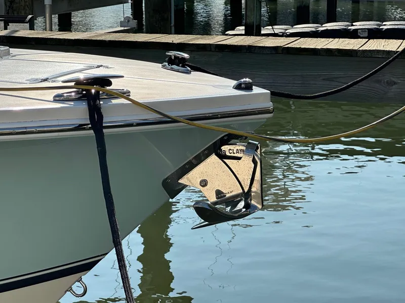 Slide: The Image of 2019 Regulator 28 boat anchored at a dock, featuring a shiny anchor. - 4