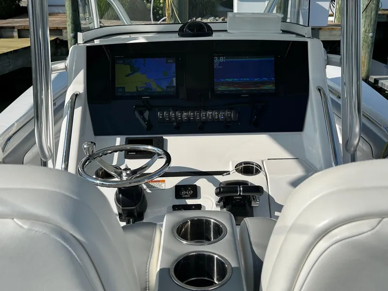 Slide: The Image of 2019 Regulator 28 boat cockpit with dual displays and steering wheel. - 6