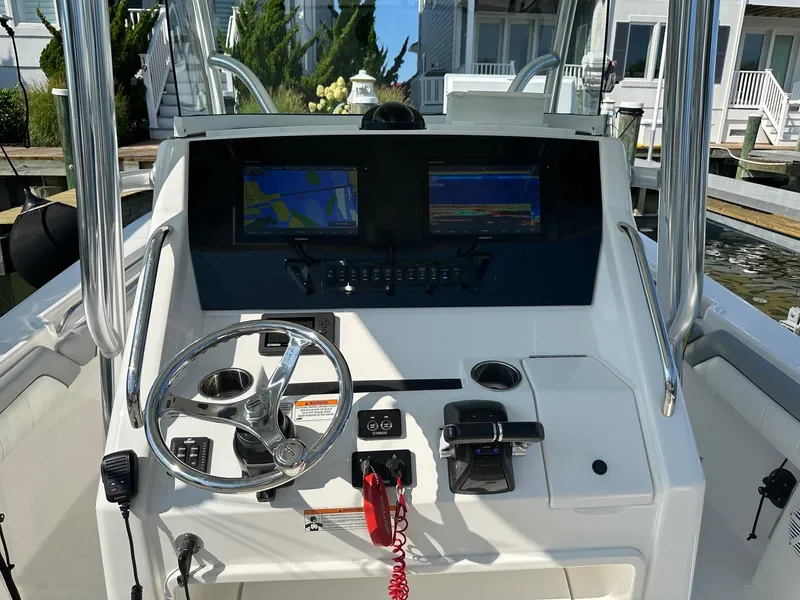 Slide: The Image of 2019 Regulator 28 boat dashboard with steering wheel and navigation screens. - 7