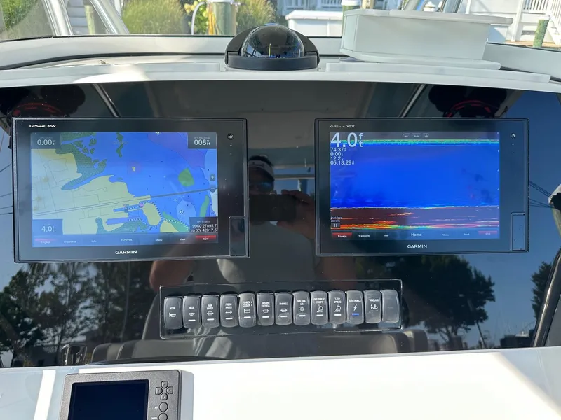 Slide: The Image of Garmin navigation displays on a 2019 Regulator 28 boat dashboard. - 8