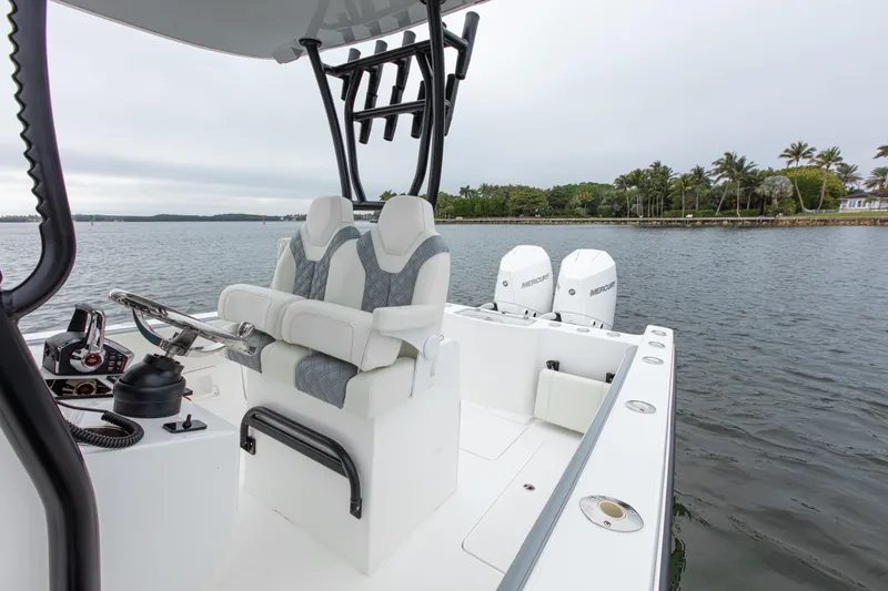 Slide: The Image of 2024 Streamline 26 CC boat with dual engines on a calm waterway. - 27