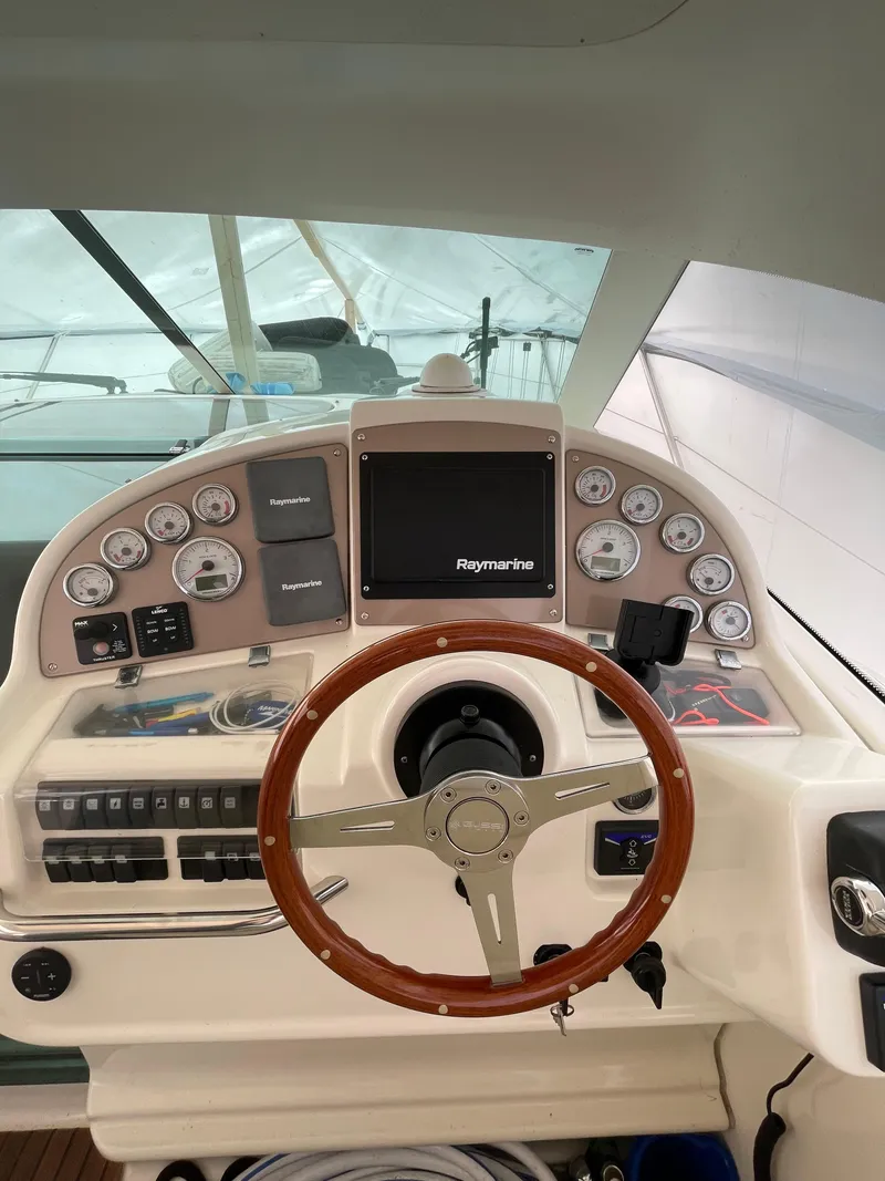 Slide: The Image of 2008 Jeanneau Prestige 34 Hardtop helm with Raymarine navigation system and wooden steering wheel. - 10