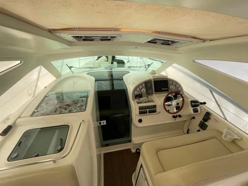 Slide: The Image of 2008 Jeanneau Prestige 34 Hardtop cockpit with steering wheel and control panel. - 11