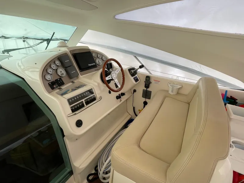 Slide: The Image of 2008 Jeanneau Prestige 34 Hardtop helm with beige seating and modern controls. - 12