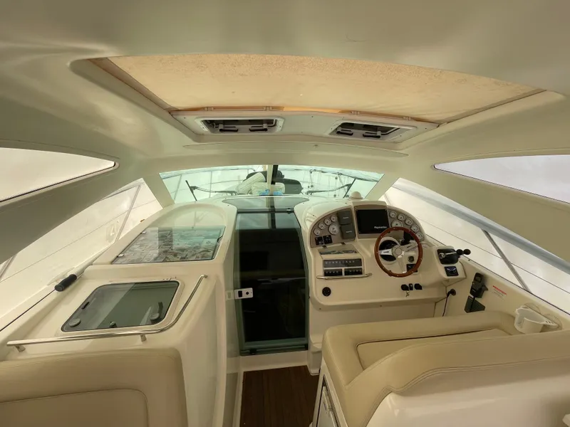Slide: The Image of 2008 Jeanneau Prestige 34 Hardtop yacht interior with helm and seating area. - 14