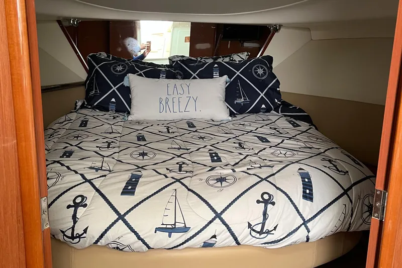 Slide: The Image of Cozy cabin interior of 2008 Jeanneau Prestige 34 Hardtop with nautical-themed bedding. - 18