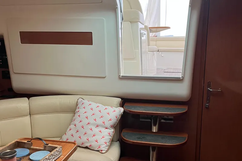 Slide: The Image of Interior of 2008 Jeanneau Prestige 34 Hardtop with cozy seating and decorative pillow. - 23