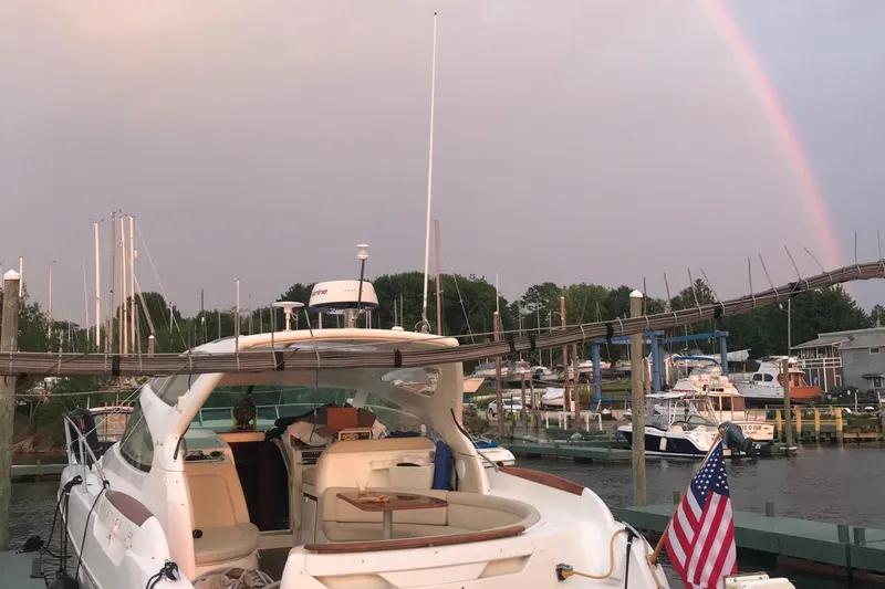 Slide: The Image of 2008 Jeanneau Prestige 34 Hardtop yacht docked with a rainbow in the background. - 26