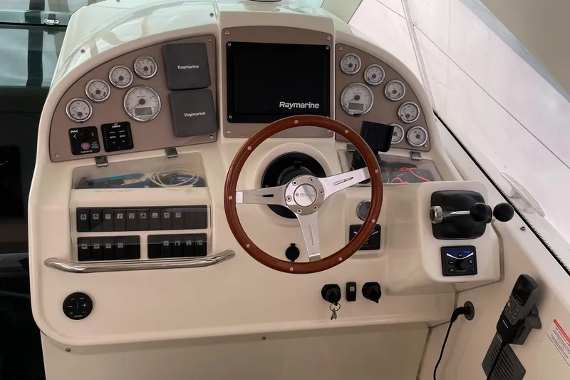 Slide: The Image of Control panel of a 2008 Jeanneau Prestige 34 Hardtop boat with steering wheel and gauges. - 28