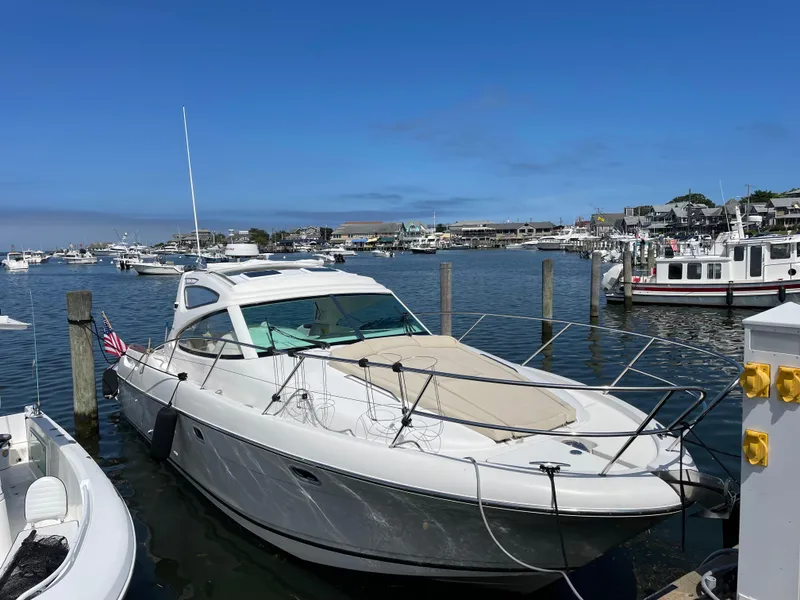 Slide: The Image of 2008 Jeanneau Prestige 34 Hardtop yacht docked in a marina under clear blue skies. - 3