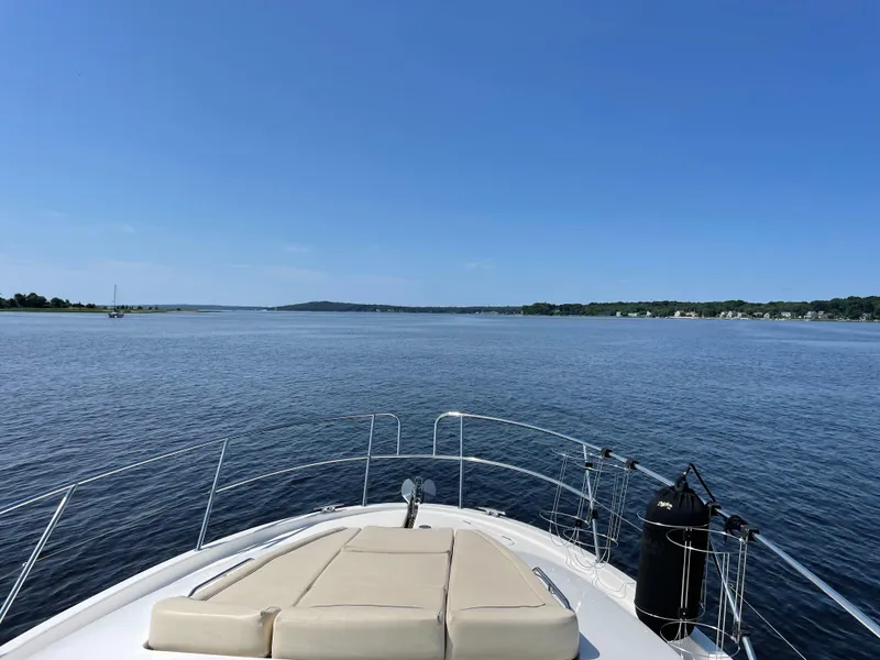 Slide: The Image of 2008 Jeanneau Prestige 34 Hardtop yacht on calm waters under clear blue sky. - 4