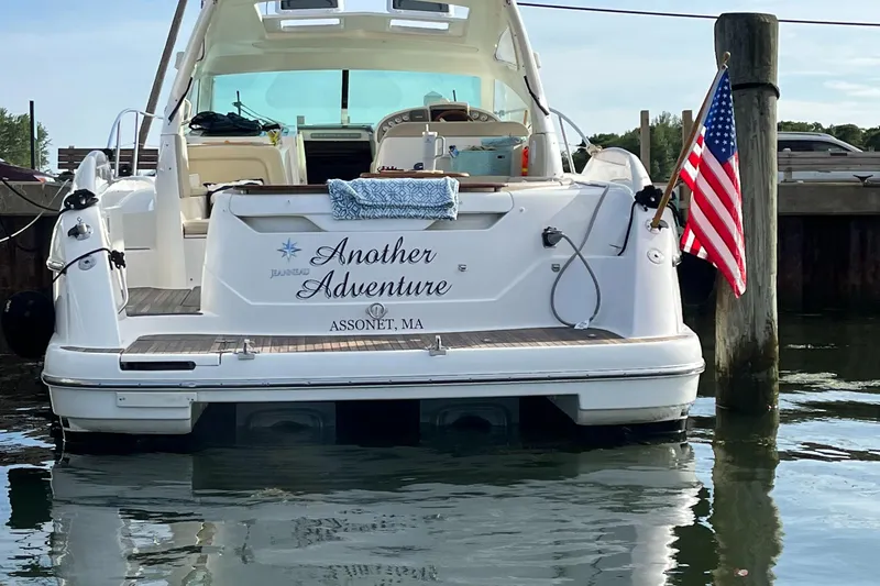 Slide: The Image of 2008 Jeanneau Prestige 34 Hardtop yacht docked, displaying "Another Adventure" and American flag. - 5