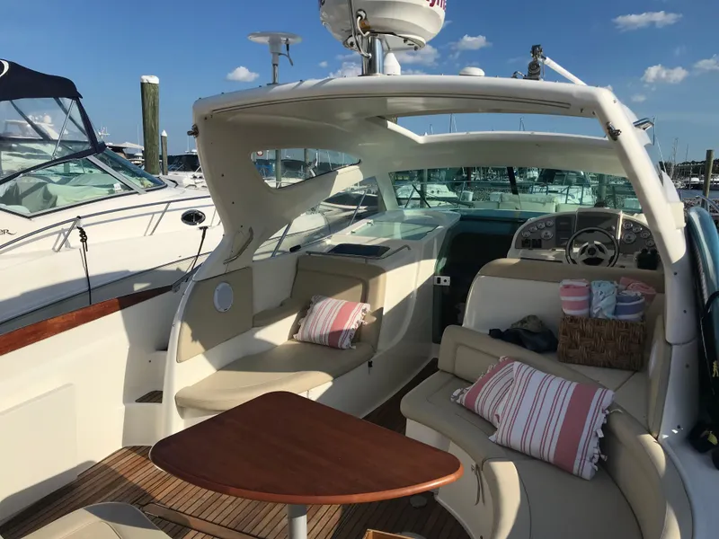 Slide: The Image of 2008 Jeanneau Prestige 34 Hardtop boat interior with seating, table, and nautical decor. - 8