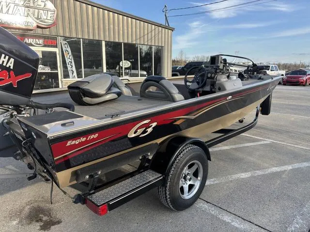 Slide: The Image of 2011 G3 Eagle 190 boat on trailer, parked outside a marine dealership. - 3