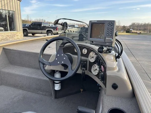 Slide: The Image of 2011 G3 Eagle 190 boat dashboard with steering wheel and navigation system. - 4