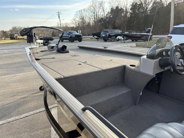 Slide: The Image of 2011 G3 Eagle 190 boat interior with steering wheel and seating, parked outdoors. - 9