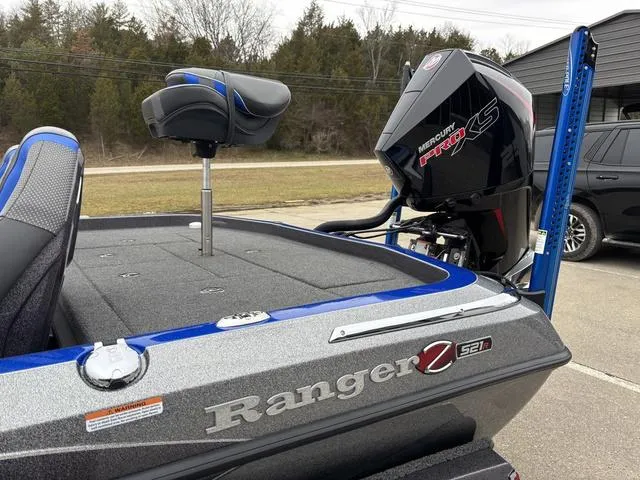 Slide: The Image of 2023 Ranger Z521R boat with Mercury Pro XS engine, parked outdoors. - 16